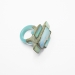 Fountain, 2015. Ring height 35 mm. Opal raw, faceted and reconstructed, cement.