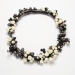 Blossoms, 2016. Necklace Ø 19 cm. White and faceted black pearls, wood, silver.