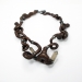 Curly, 2016. Necklace Ø 19 cm. Hazelnut wood, smoky quartz, silver, paint.
